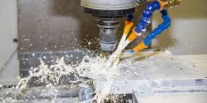 A 5-axis CNC milling machine cutting a complex metal part, showcasing our precision engineering capabilities.